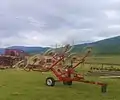 Wheel-finger rake (in folded transport position) for raking hay or straw into windrows for the baler