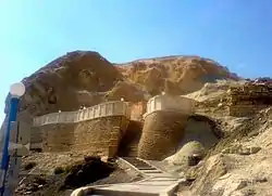  A hill with some walls and steps leading to a mosque