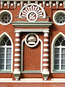 Facade of the "Bread House". "Х С" monogramm; Translates to "Хлеб-Соль" (Bread-Salt, "hospitality")