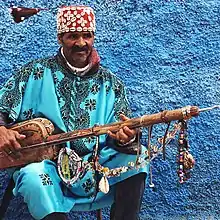 Image 15A Gnawa street performer wearing traditional Gnawi clothing in Rabat's Qasbat al-Widaya (from Culture of Morocco)