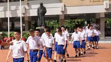 Boy's uniform of Assumption College (Thailand) with dark blue shorts