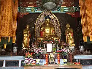 Temple with Buddha image, flanked by Ānanda and Mahākāśyapa