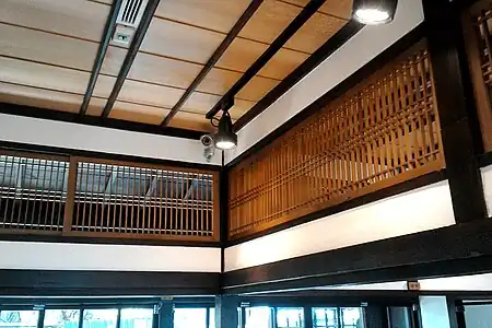 A ranma fanlight, unfilled for air circulation. Note fukiyose, clustered spacing of the laths.