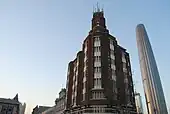 The Gulf Building (or Po Hai Building), built in 1937, was the tallest building in Tientsin before the 1960s. Tianjin World Financial Center can be seen behind.