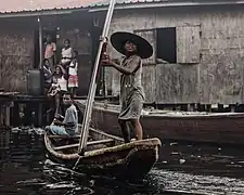 Boys paddling a canoe is a common view at Makoko