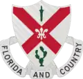 The shield is white, the old Infantry color. The saltire is taken from the Florida State flag.  The sheathed sword, from the Spanish War service medal, represents service during that war.  The cactus symbolizes service on the Mexican Border, and the fleur-de-lis, service during World War I.