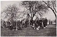 Group of male soldiers sitting and standing.