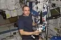 Expedition 8 mission commander and science officer Michael Foale is shown wearing a customized Lower Extremity Monitoring Suit (LEMS) and balancing on the footplate of a special track attached to the Human Research Facility (HRF) rack in the Destiny laboratory to perform a calibration for the Foot Reaction Forces During Spaceflight (Foot) experiment. - NASA Image: ISS08E06860