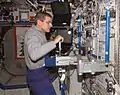 View of astronaut Jeffrey N. Williams, NASA Expedition 13 science officer and flight engineer, inserting a subrack payload into the Human Research Facility (HRF) in the U.S. Laboratory, Destiny. - NASA Image ISS013E38340