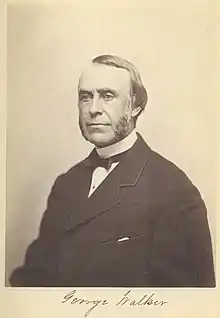 A browning black and white photograph of George Walker, a man with a high hairline and part and mutton chops wearing a band collar, small back bow tie and heavy dark suit jacket