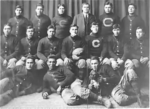 The 1911 "Carlisle Indians" football team pose with a game ball from the upset of Harvard. Coach "Pop" Warner (standing, third from right) and Jim Thorpe (seated, third from right) are pictured.