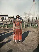 1913 photo of Mongol woman next to the Khais (hedge fence) of Zuun Khuree.