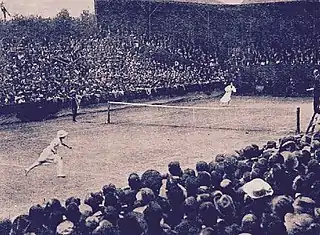 Lenglen and Lambert Chambers in the middle of a point in front of a sell-out crowd