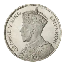 A crowned portrait of George V in royal dress, with the encircling text GEORGE V KING to the left, and EMPEROR to the right.