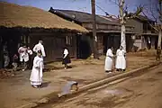 Elderly women waiting for a bus in post-Korean War Seoul (1953)