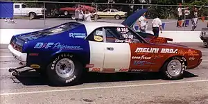 Shows a 1970 AMC Javelin dragstrip car at the starting lane