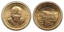 A gold medallion depicting a man and a rural farm scene