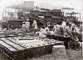 French colonial troops with site preparation materials.