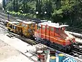 Preserved electric locomotive no 32 and ballast tamper Y at Thision station sidings.