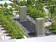 View of the fountain shows glass brick towers from rooftop nearby.