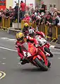 2013 Isle of Man TT Superbike Race Lap 4 – John McGuinness (3), Michael Dunlop (6) & Cameron Donald (2) Parliament Square, Ramsey 2 June 2013.