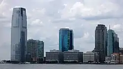 The tower seen with the Jersey City skyline from lower Manhattan