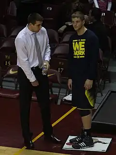 Two caucasian men talking at courtside