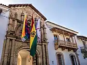 The entrance of the Casa de la Libertad, with three flags