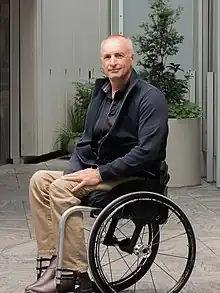 Duane Kale in outdoor urban setting in wheelchair