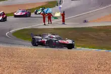 The winning car, leading three others