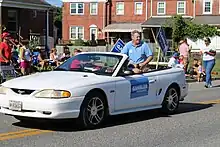 Gansler sits in the back of his car in the July 4 parade in Dundalk, Maryland