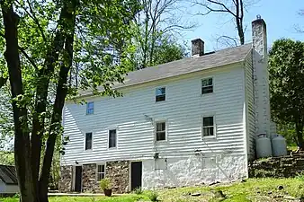 House on Quarry Road with stone bank cellar