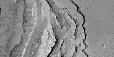 Tilted layers formed when ground collapsed, as seen by HiRISE, under HiWish program.