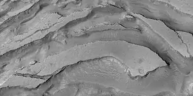 Tilted layers formed from ground collapse, as seen by HiRISE, under HiWish program.