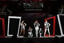 2NE1 onstage, in different poses