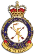 Crest of 34 Squadron, Royal Australian Air Force, featuring winged messenger in gold, two crossed arrows, and the motto "Eo et redeo"