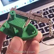 3DBenchy being measured with a caliper-like keyring