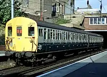 Class 416 train in British Rail blue/grey livery calls at Dalston Kingsland station