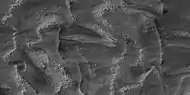 Layers breaking up into boulders in Galle Crater, as seen by HiRISE under HiWish program Location is Argyre quadrangle.