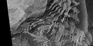 Close view of layers in Schiaparelli Crater, as seen by HiRISE under HiWish program Dark sand is visible on some layers.