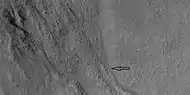 Close view of gullies with small channels, as seen by HiRISE under HiWish program Arrow points to one small channel in a larger valley.