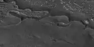 Close view of upper plain unit eroding into hollows, as seen by HiRISE under HiWish program  Break up begins with cracks on the surface that expand as more and more ice disappears from the ground.