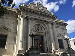 A heavy white marble doorway with double columns on either side