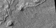 Close view of layers, as seen by HiRISE under HiWish program Boulders are also visible in the image.