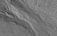 Close view of gullies, as seen by HiRISE under HiWish program  Streamlined features are visible in gully channels.