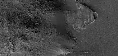 Close view of exhumed crater, as seen by HiRISE under HiWish program  This crater is and was under a set of dipping layers.