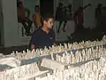 A kid stares at firework filled racks just ready for take off in Camajuani streets. Several blocks are filled with these.