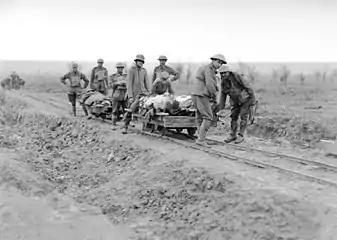 5th Australian Field Ambulance Company soldiers evacuating wounded from the front near Ypres in trench railway hand cars.