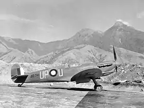 Single-engined military monoplane parked on airfield