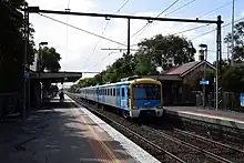 A modern train arriving at an old station